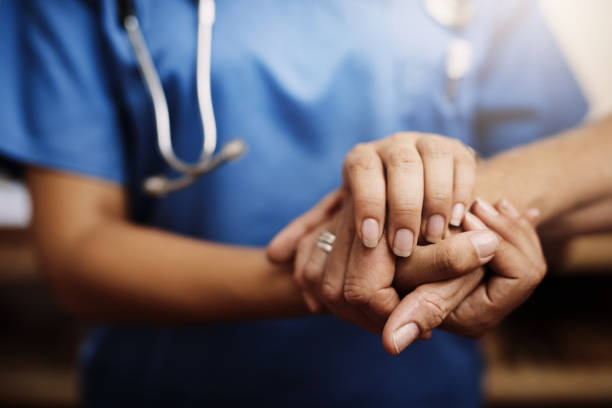 Cropped shot of an unrecognizable female nurse holding a senior woman's hands in comfort