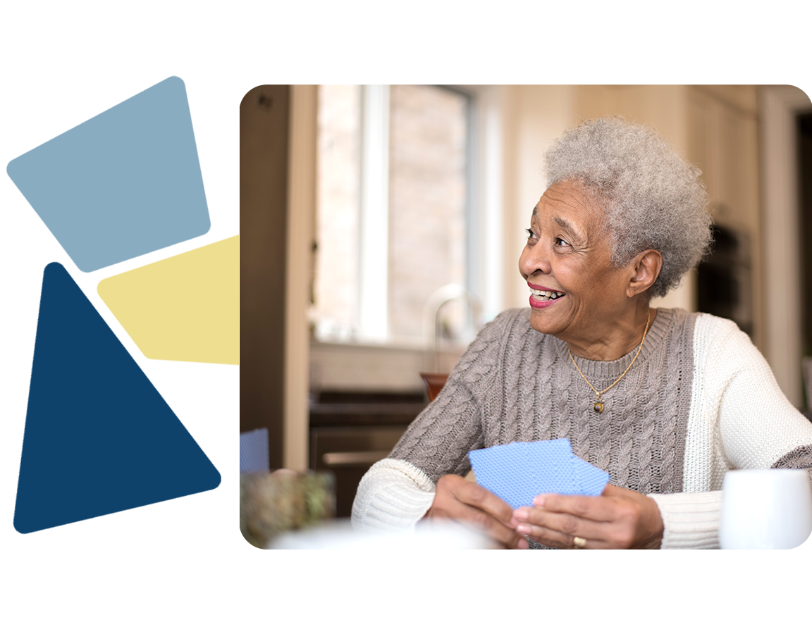 Older woman smiling playing cards
