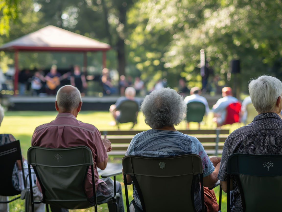 A group of seniors enjoy an outdoor concert.